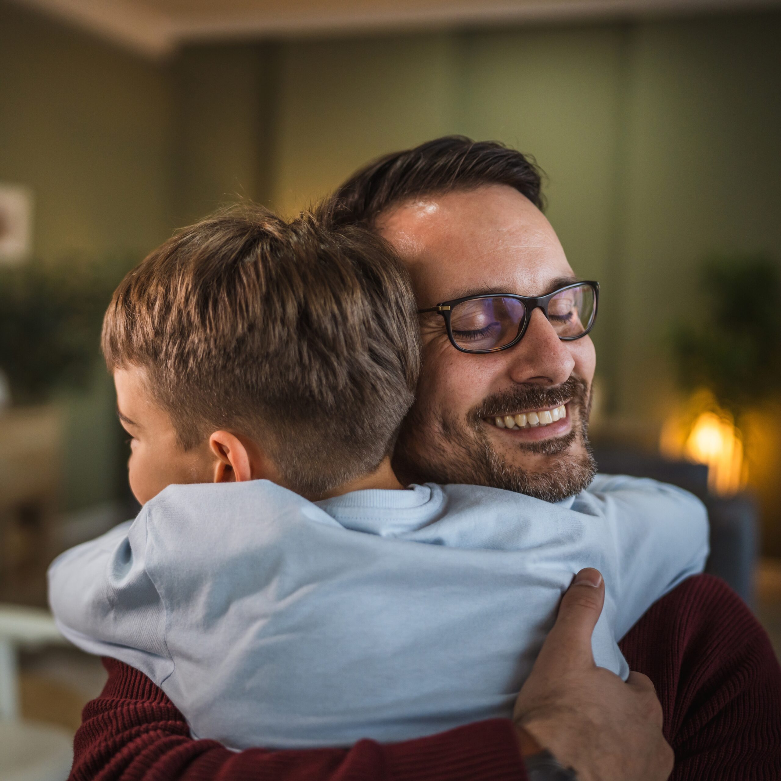 Dad and son hugging.